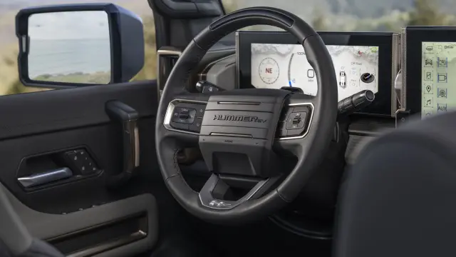 Interior shot of the 2024 GMC HUMMER EV SUV steering wheel with 12.3-inch digital driver information center display.