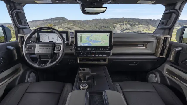 Front seat view of Lunar Shadow interior in the 2024 GMC HUMMER EV SUV overlooking mountain vista.